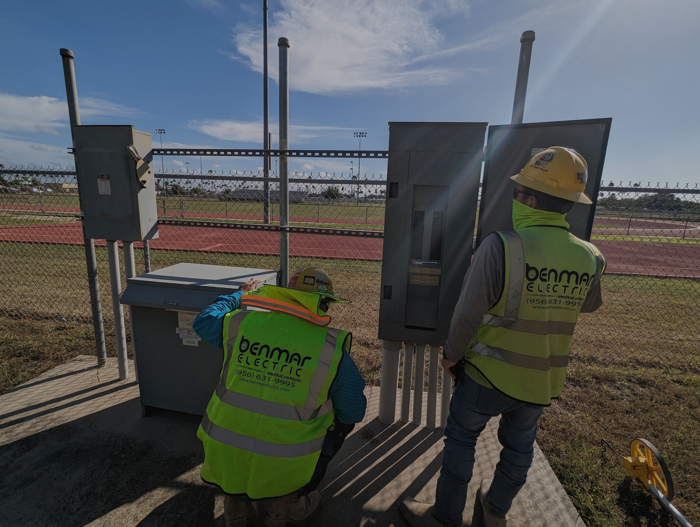 Benmar Electric crew inspecting electrical panels on site